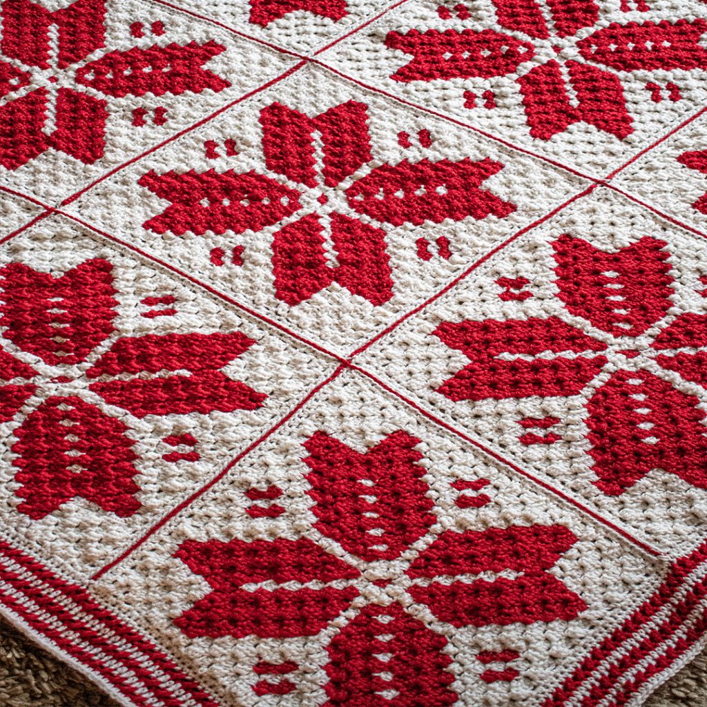 My Nordic Snowflake blanket is made in red and white