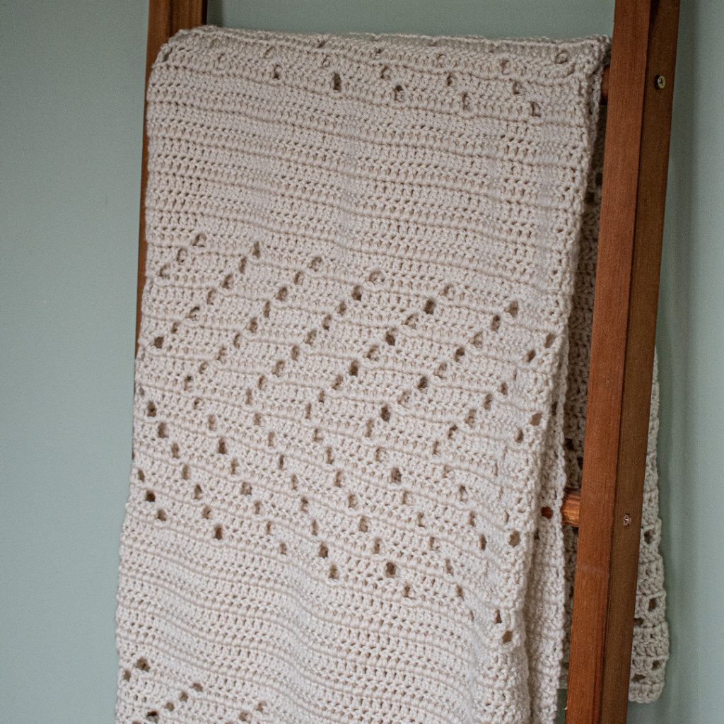 This easy filet crochet blanket pattern has an elegance to it because of its simplicity