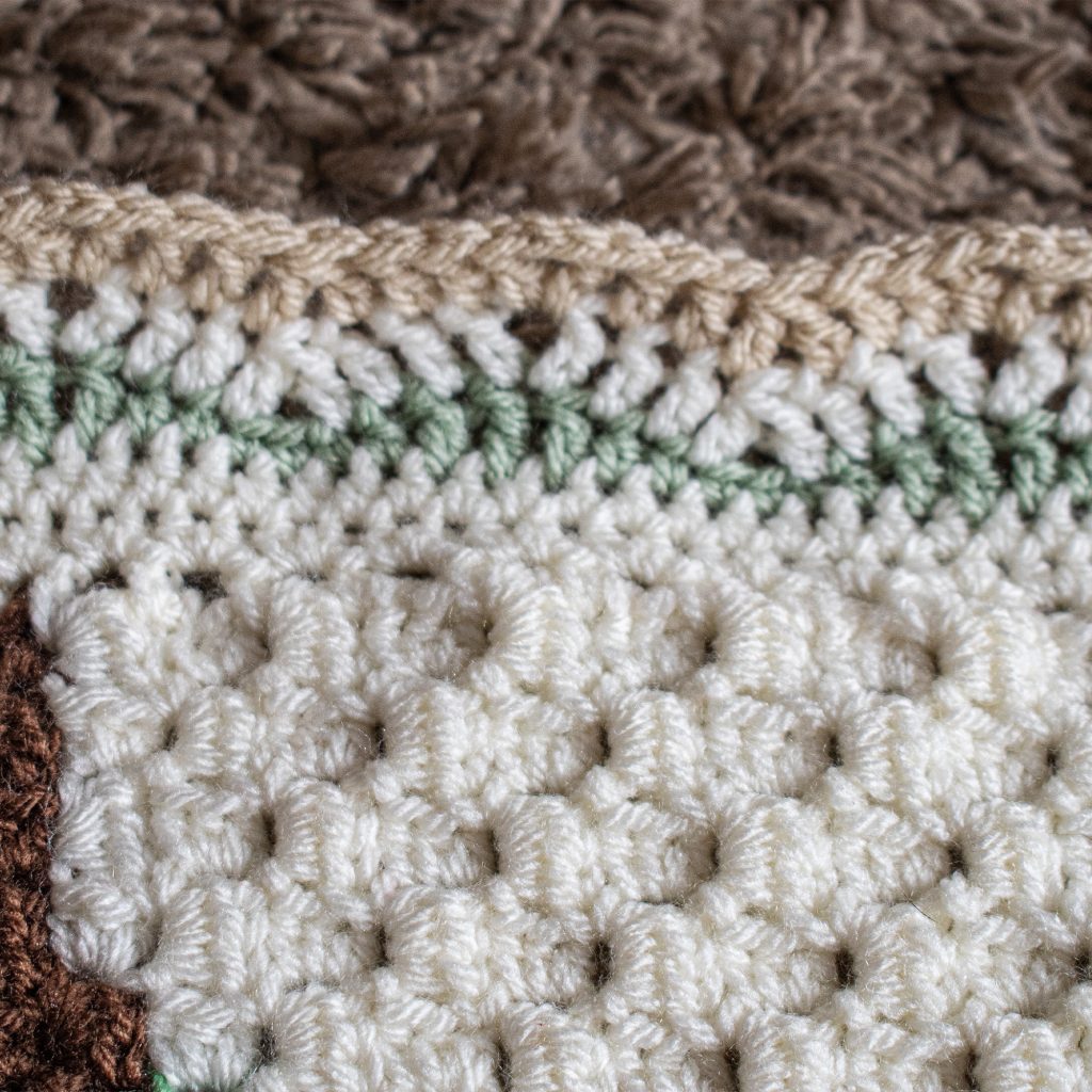 The gentle waves on this crochet blanket border make it unisex