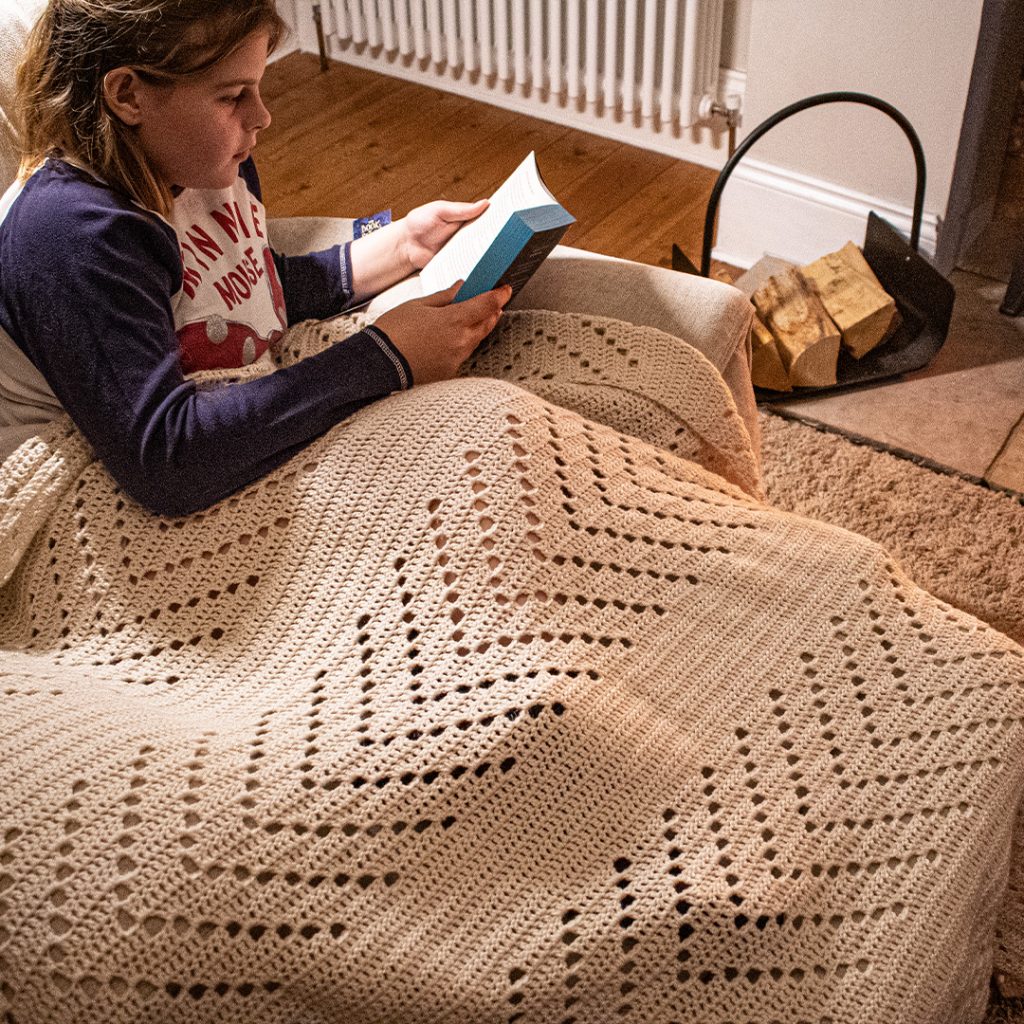 my daughter nabbed this easy filet crochet blanket as soon as it was finished!