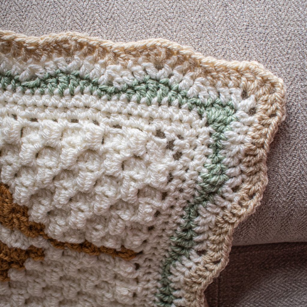 Using a different colour for each round really makes this crochet blanket border pop!