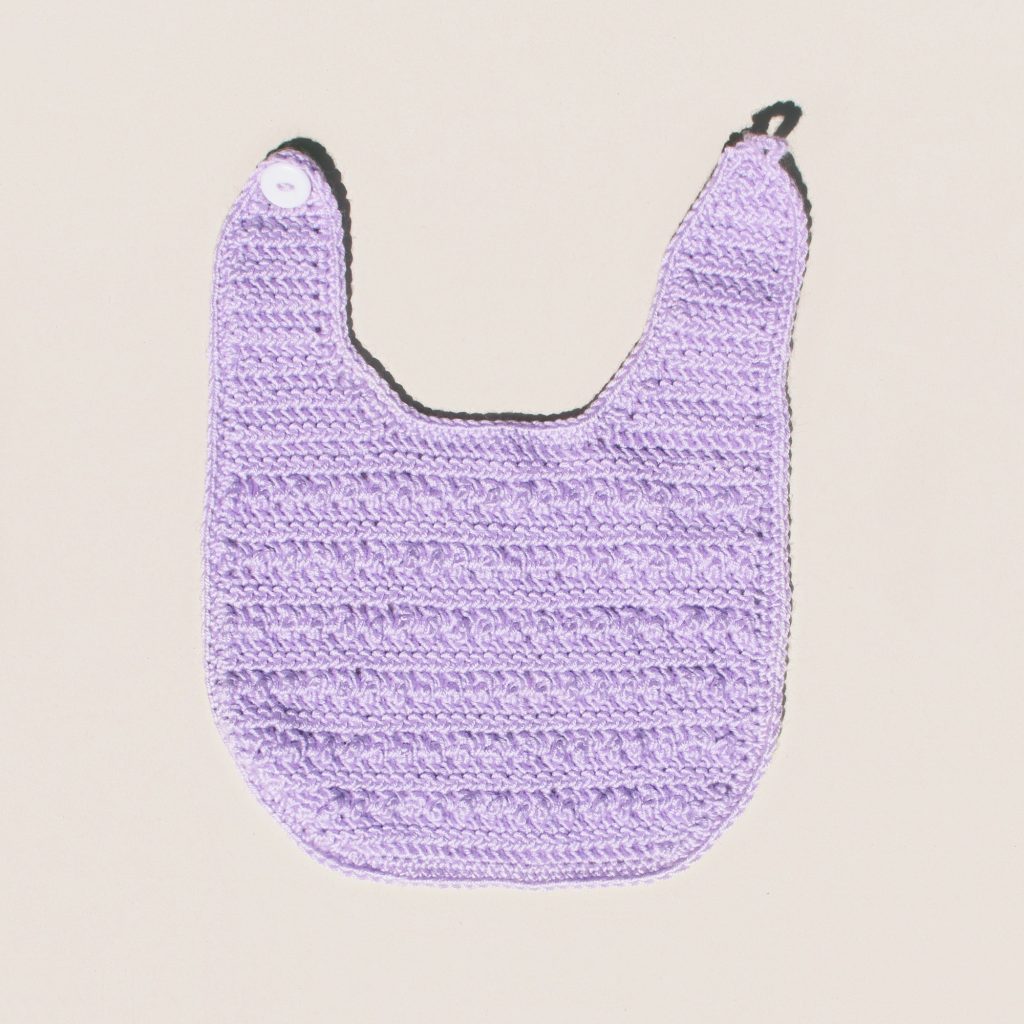 This baby bib pattern also works up well in a solid colour
