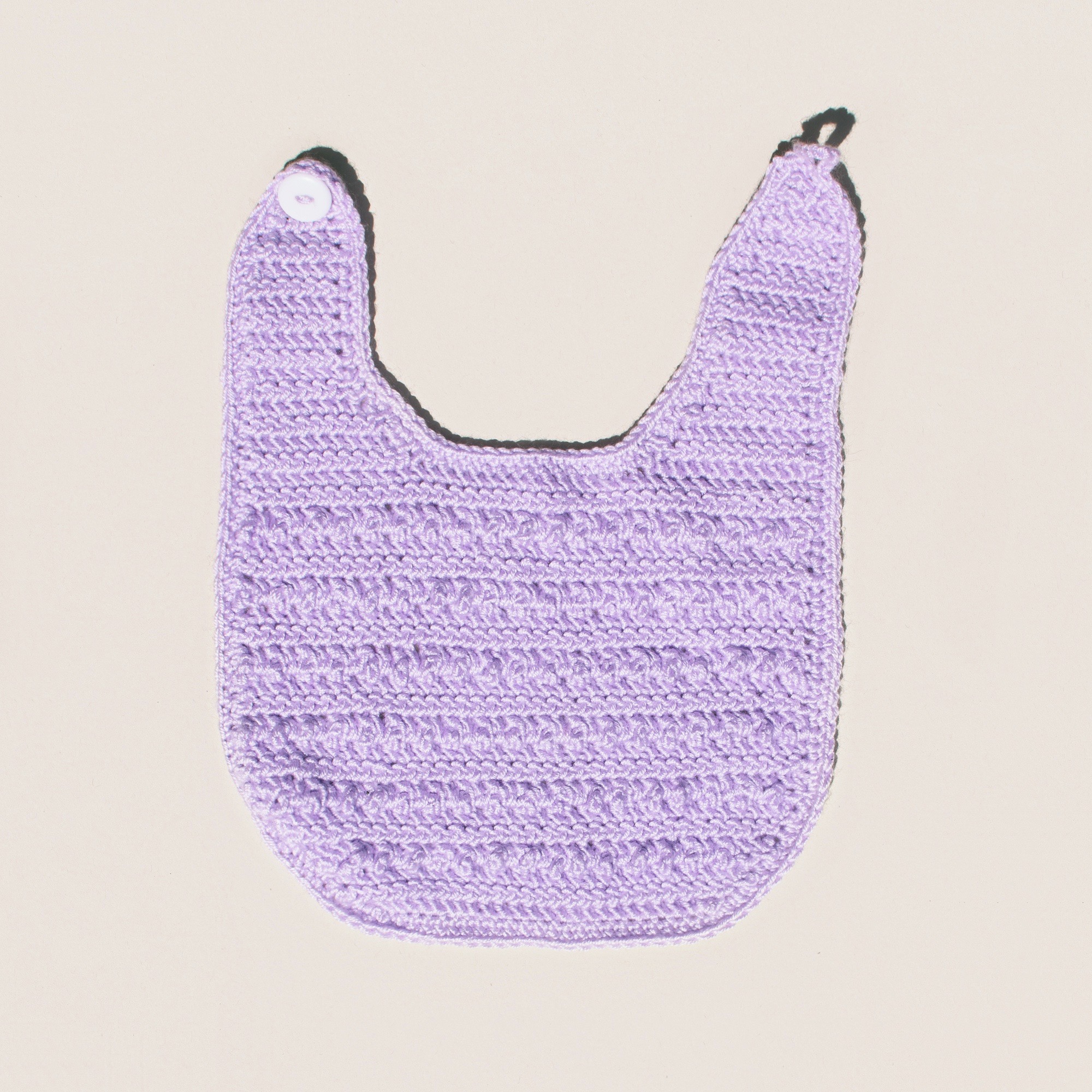 This baby bib pattern also works up well in a solid colour