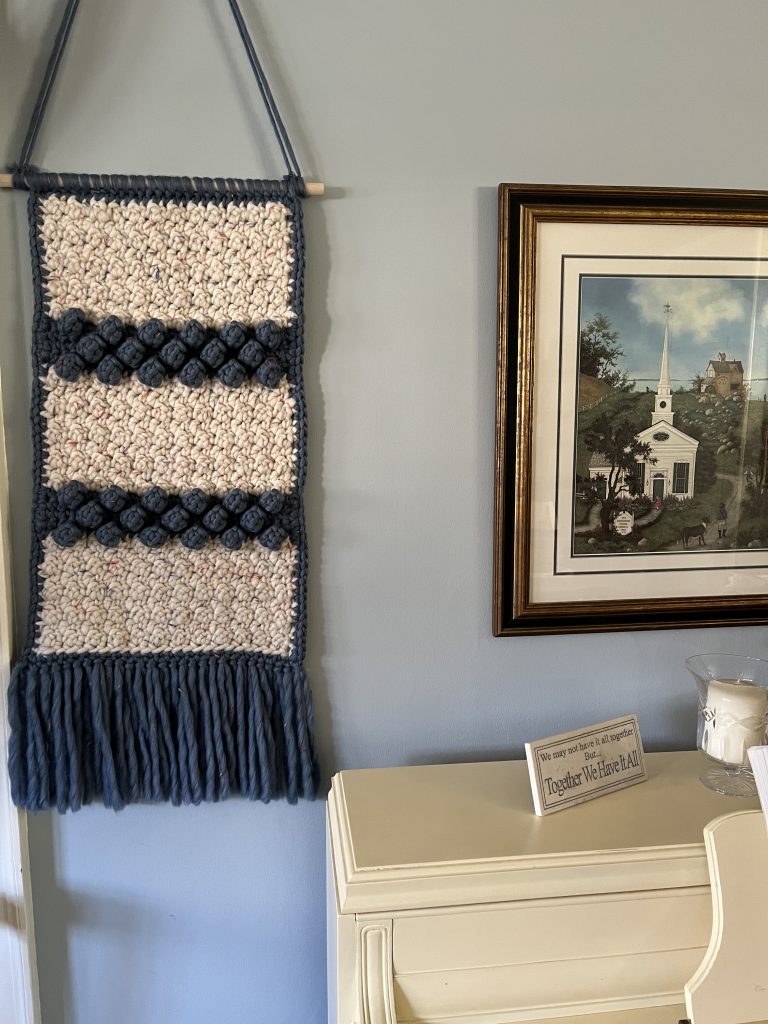 This crochet wall hanging is full of gorgeous texture and is a great unisex piece.