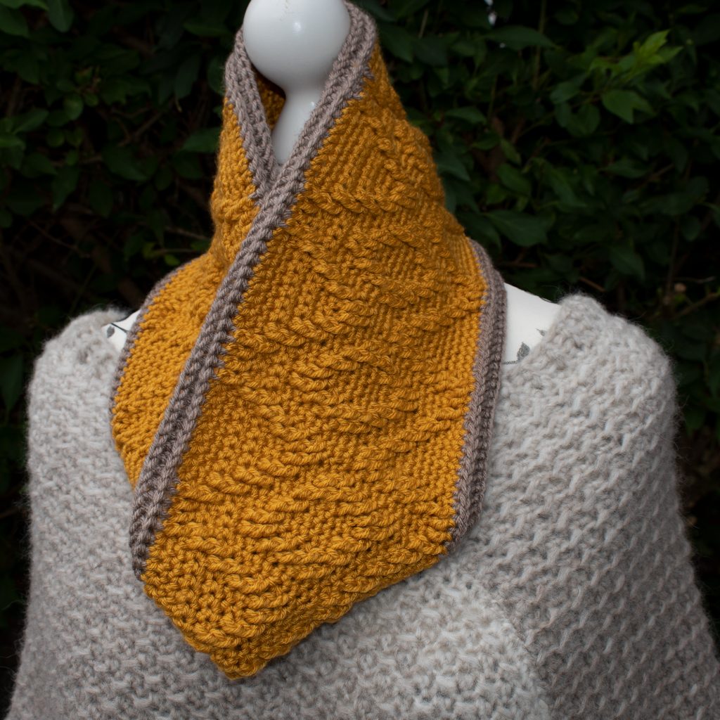 Make your cabled cowl in one colour for a more subtle texture